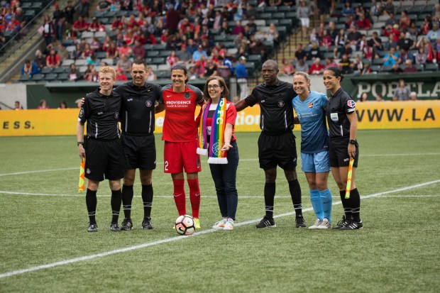 Oregon Governor Kate Brown tosses the coin before kick-off of a Portland Thorns game_