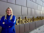Emma Hayes posing by the Chelsea FC sign